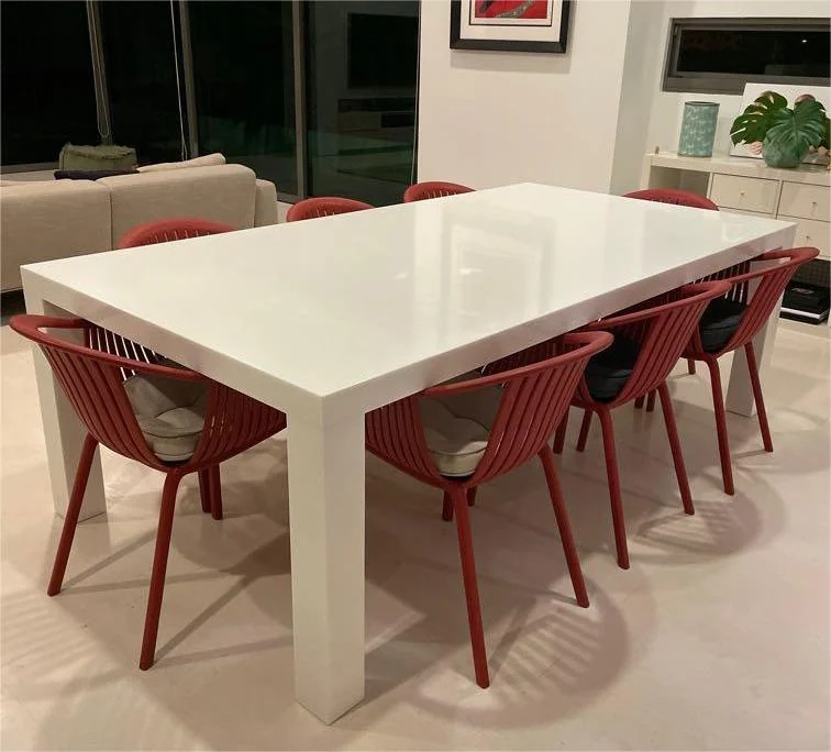 Complete rectangular solid surface dining table with supporting legs and chairs