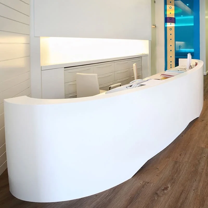 Curved white reception counter in a commercial interior