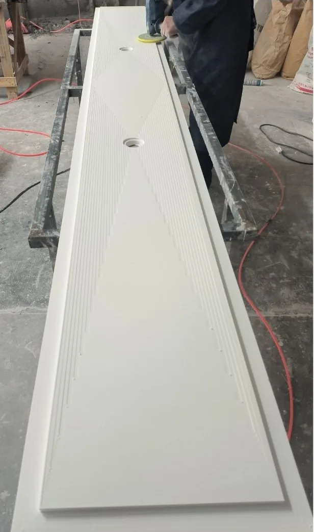 An ESHINE fabricator finishing a custom-made solid surface display component